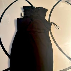 neckline and cap sleeves for a demure look. Finished with a back zipper